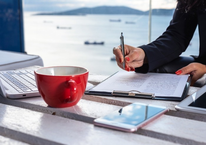 Woman Filling out Boat Insurance documents. 