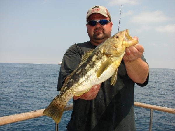 Happy Man Caught a Fish on a fishing Trip – California Yacht Marina