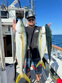 Man holding fish in a small yacht - California Yacht Marina